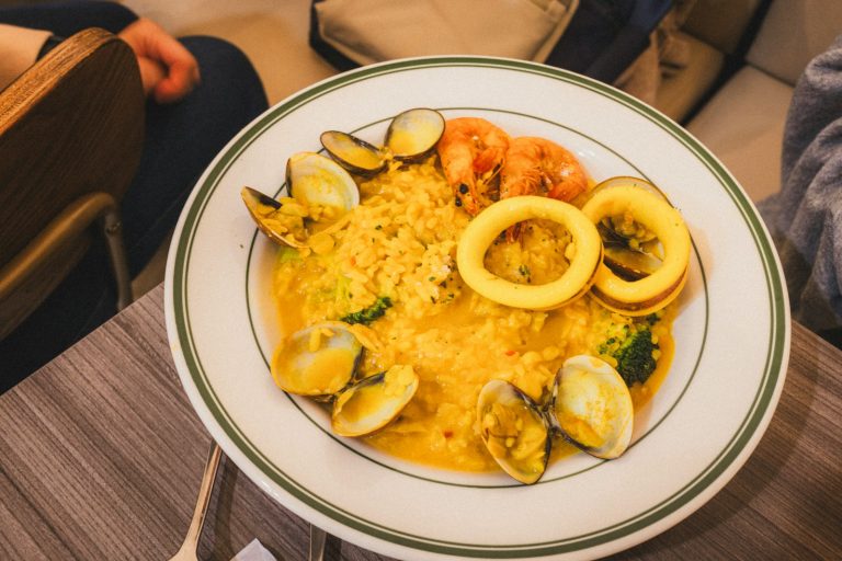 A plate of seafood paella with shrimp and calamari