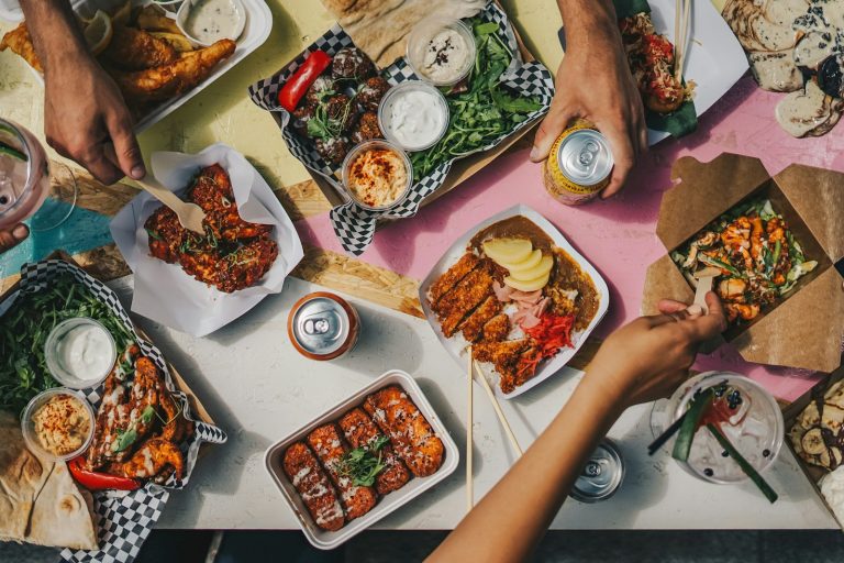 a group of people sitting around a table eating food